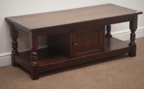 Old Charm oak rectangular coffee table, turned supports joined by an undertier with single cupboard,