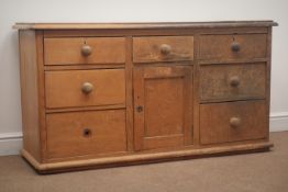 Early 20th century Pine dresser base, seven graduating drawers, single cupboard door, W135cm, H74cm,