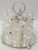Victorian silver-plated six bottle cruet with central ring handle, oval base and bun feet,
