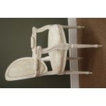 French style white elbow chair, upholstered back and seat, carved arms, turned and reeded supports,