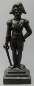 Cast iron fireside figure of Wellington depicted standing resting on his sword,