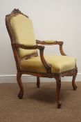 French style walnut framed elbow chair, shaped floral carved cresting rail, upholstered back,