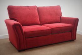 Two seat sofa bed, upholstered in red ,