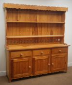 Pine kitchen dresser, shaped cornice, two plate racks, three drawers and three cupboard doors,