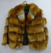Short fox fur coat with suede spacers,