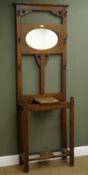 Early 20th century oak hallstand, projecting cornice with mirrored back, solid end supports, W66cm,