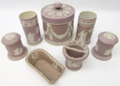 19th century Wedgwood lilac Jasperware tobacco jar, pipe rest, pair cylindrical jars and covers,