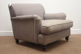 Large armchair upholstered in grey fabric, turned feet on castors,