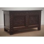 Early 19th century heavily carved coffer with hinged lid, panelled sides and stile supports, W110cm,
