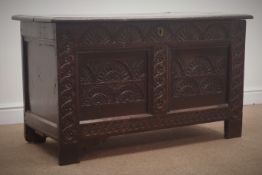Early 19th century heavily carved coffer with hinged lid, panelled sides and stile supports, W110cm,