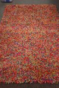 Modern long pile multi coloured rug,