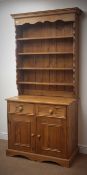 Pine kitchen dresser, projecting cornice, four plate racks, two drawers above two cupboard doors,