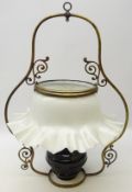 Early 20th century brass framed hanging oil lamp with Japanned well and opaque frilled edged shade,