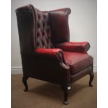 Georgian style wingback armchair upholstered in ox blood red leather,