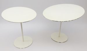 Two 1960s circular white finish cast metal stands, tilted top with slender stems and circular base,