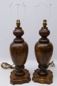 Pair carved oak of knopped baluster form on shaped base,