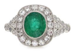 Platinum (tested) oval emerald and diamond ring,