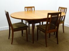 G Plan extending circular table turned tapering supports (W122cm, H73cm, D151cm) and four chairs,