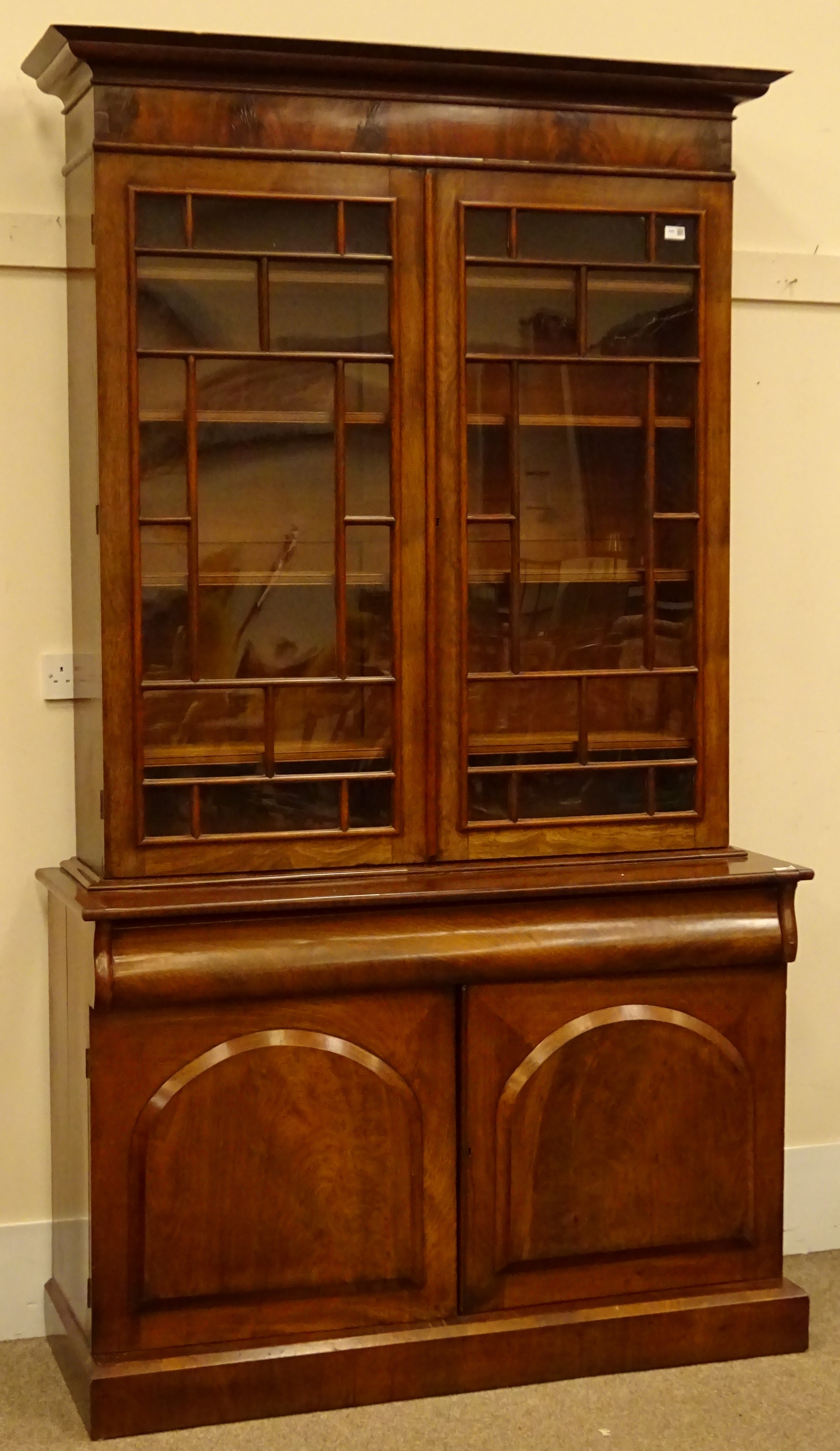 Victorian figured mahogany bookcase on cupboard, projecting cornice,