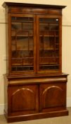Victorian figured mahogany bookcase on cupboard, projecting cornice,