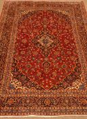 Kashan red ground rug, central medallion, floral field, repeating border,