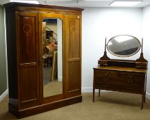 Edwardian inlaid mahogany bedroom suite comprising mirror door wardrobe enclosing hanging rail and