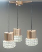 Mid century teak light fitting with three drop down clear glass pendants and copper mounts,