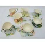 Seven Franz sculptured porcelain cup, saucer & spoon sets comprising Bee, Calla Lily,