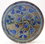 Persian earthenware bowl glazed in blue tones with floral motif,