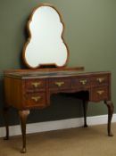 Mid 20th century serpentine front walnut dressing table with shaped mirror above,