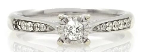 White gold single stone illusion set diamond ring, with diamond shoulders,