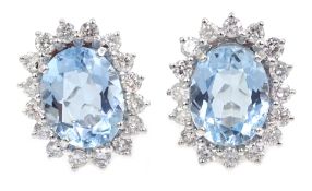 Pair of 18ct white gold aquamarine and diamond cluster stud earrings, hallmarked,