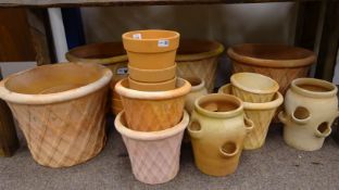Twenty two terracotta plant pots and platers,