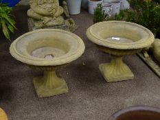 Pair composite stone urn planters, circular form with egg and dart rim and gadroon underside,