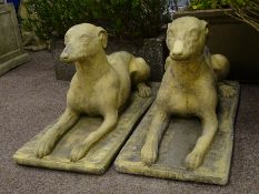 Pair composite stone recumbent dogs,