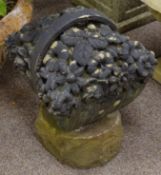 Carved West Riding stone flower basket on rough cut plinth,