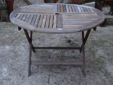 Teak garden table, circular slatted top on folding base,