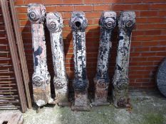 Set of five cast iron bollards, square colums decorated with roundels,