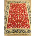Kashan red ground rug, blue floral repeating border,