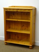 Solid pine bookcase, raised shaped back, carved frieze, two adjustable shelves, turned supports,