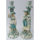 Pair 19th century porcelain candlesticks modelled as a male and female leaning against a tree