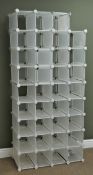 Modern adjustable modular shoe racking system with 32 compartments Condition Report