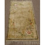 Chinese silk beige ground rug with floral spandrels,