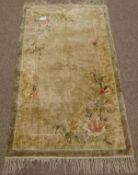 Chinese silk beige ground rug with floral spandrels,