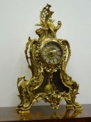 Rococo style cast brass mantle clock, circular dial with visible pendulum, modern quartz movement,