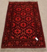 Eastern red ground wool rug, repeating border,