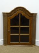Early 20th century Dutch wall hanging corner cupboard, shaped glazed door enclosing two shelves,