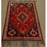 Iranian red ground wool rug, intricate lozenge centre,