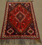 Iranian red ground wool rug, intricate lozenge centre,