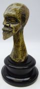 20th century Shona carved serpentine stone bust of a male figure on turned ebonised base,